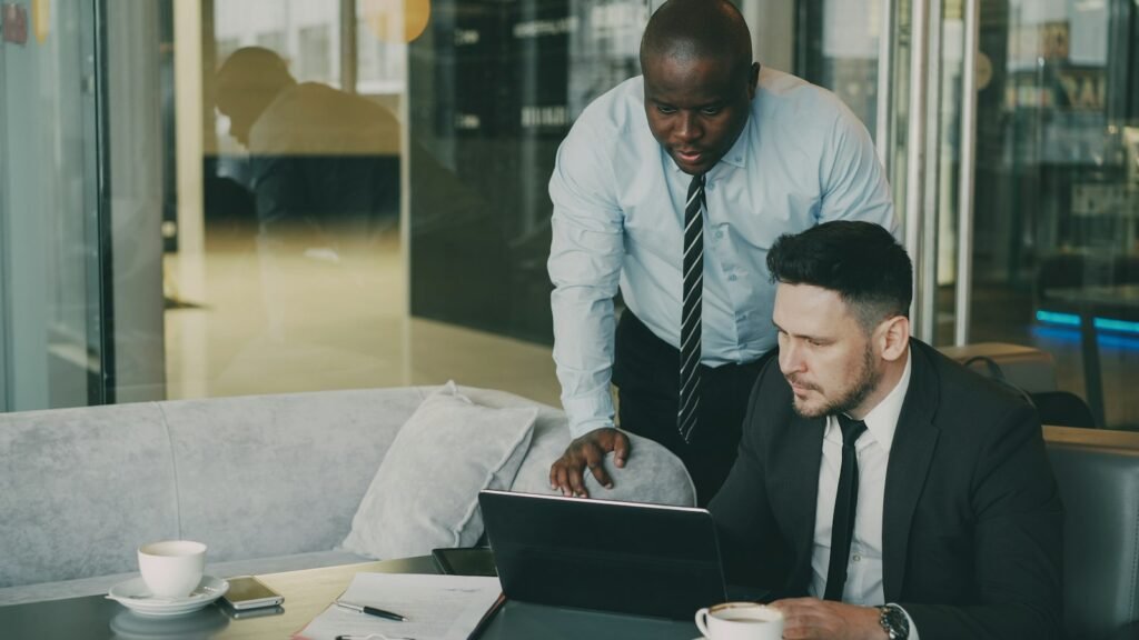 Two people seated at a table working through documents together