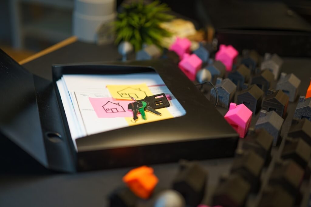 Property settlement documents and keys laid out on a desk