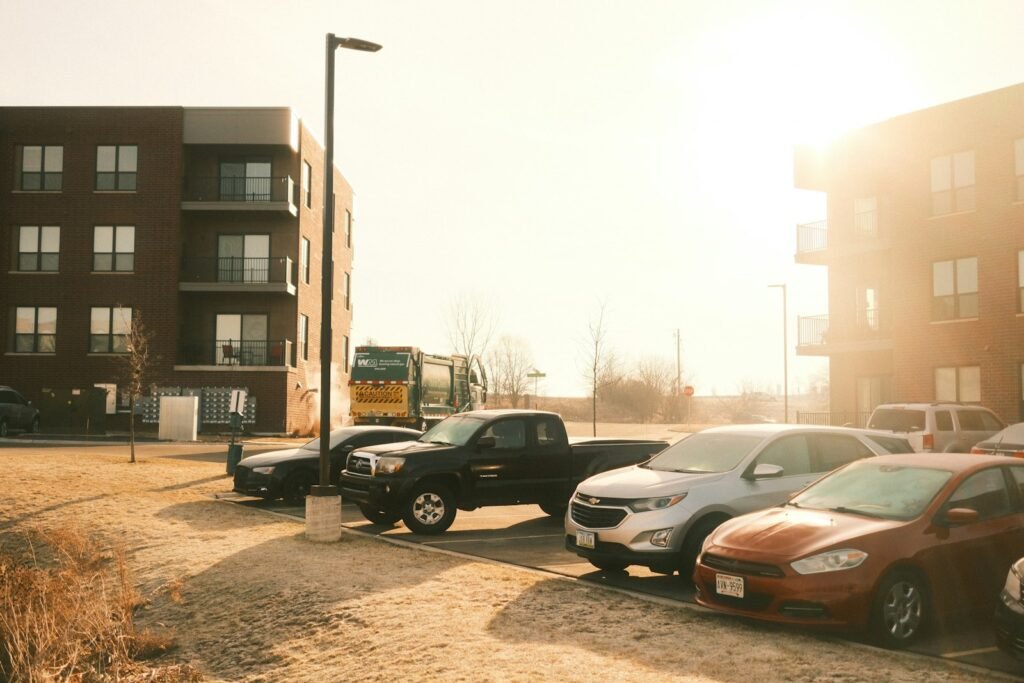 Cars parked in a residential car park beside apartment buildings