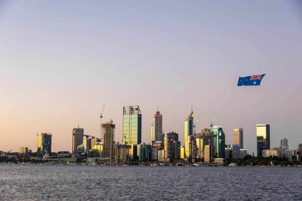 Australian city skyline at sunset with a flag flying