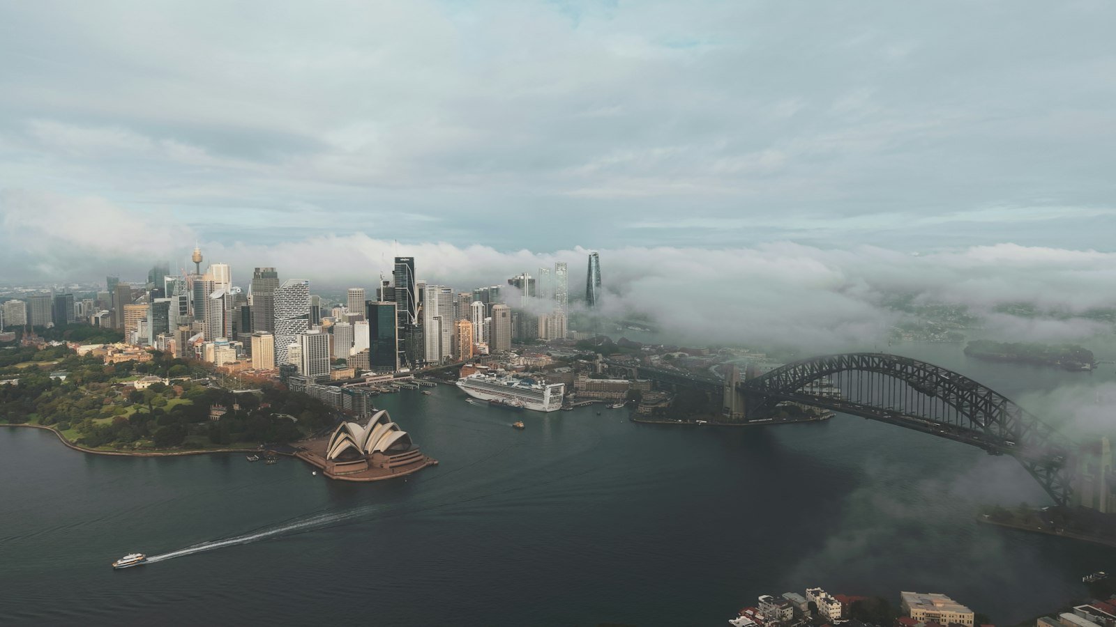 Sydney skyline in fog, with the Opera House and Harbour Bridge visible