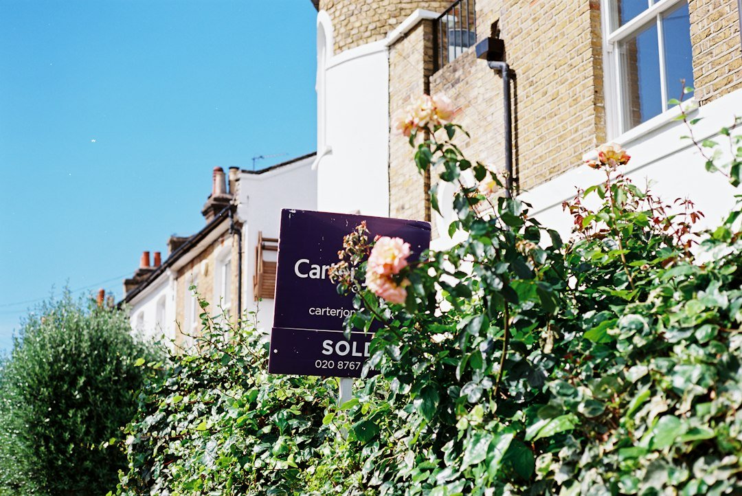 Sold sign in the front garden of a house
